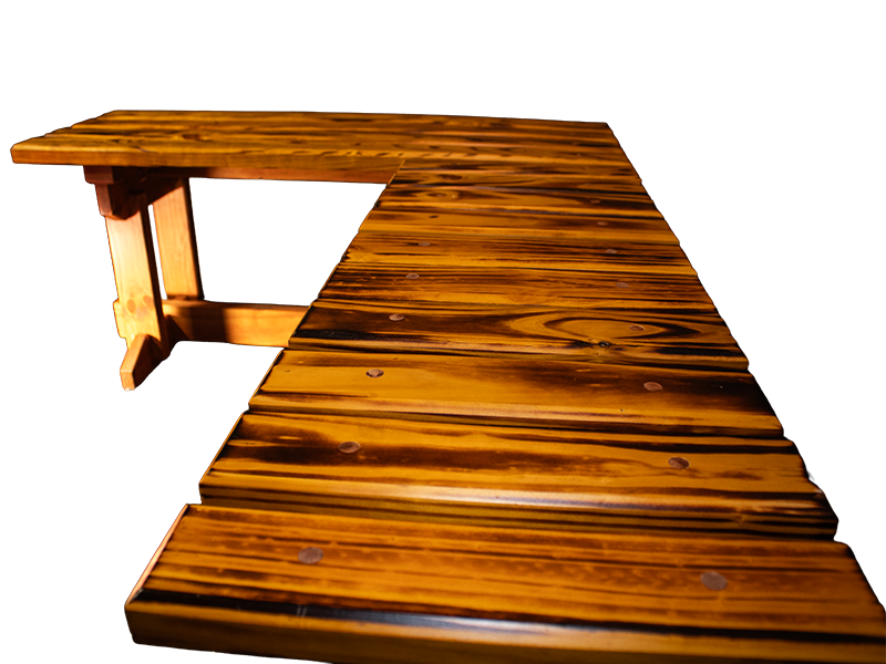 L-shaped slatted pine bench with amber top and dark walnut-stained base.