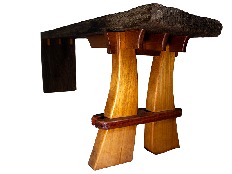 Weathered mahogany waterfall bench with sculpted split leg and purple heart accents., split leg view.