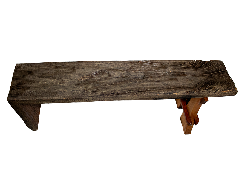 Weathered mahogany waterfall bench with sculpted split leg and purple heart accents. Top horizontal view.