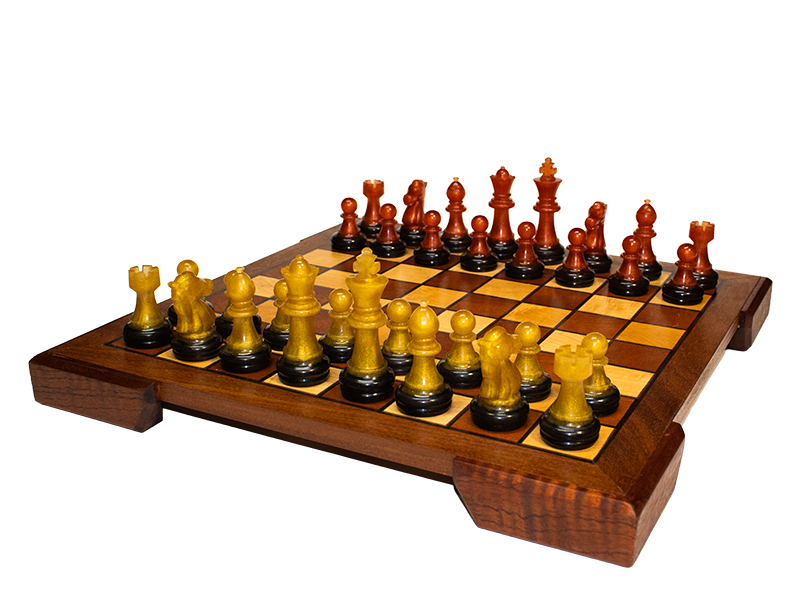 Chessboard made from Mahogany and Hard Maple with an Ipe border and Spanish Cedar feet and black resin lines, side view with gold and copper resin chess pieces.